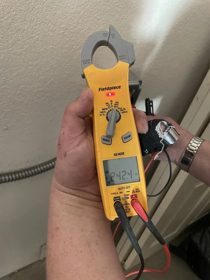 Voltage testing with clamp meter during Outlet Installation in Pittsfield